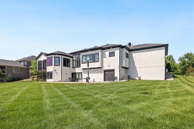 8605 NE Shl Creek Pkwy, Kansas City, MO 64157 - rear view of house featuring a lawn, stucco siding, and central air condition unit