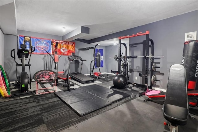 8605 NE Shl Creek Pkwy, Kansas City, MO 64157 - exercise room with a textured ceiling and baseboards