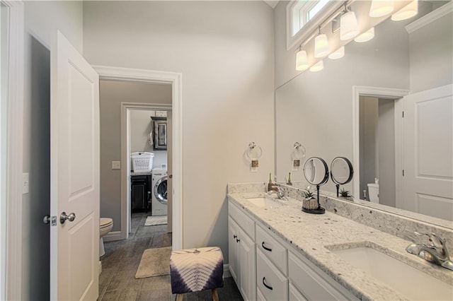 25383 W 144th Ct, Olathe, KS 66061 - full bathroom with toilet, washer / dryer, double vanity, and wood finished floors