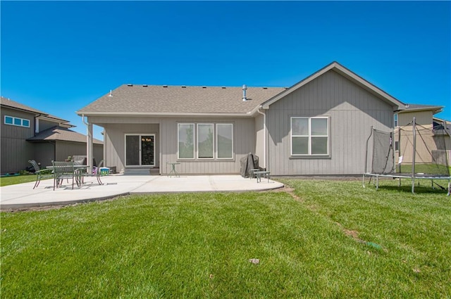 25383 W 144th Ct, Olathe, KS 66061 - back of property featuring a patio area, a trampoline, and a yard