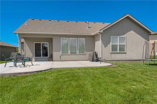 25383 W 144th Ct, Olathe, KS 66061 - back of property with a patio, a trampoline, a lawn, and roof with shingles