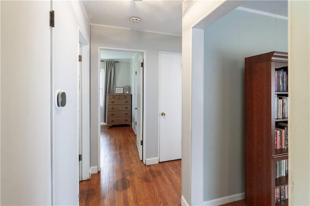 8401 England St, Overland Park, KS 66212 - corridor featuring wood finished floors, crown molding, and baseboards