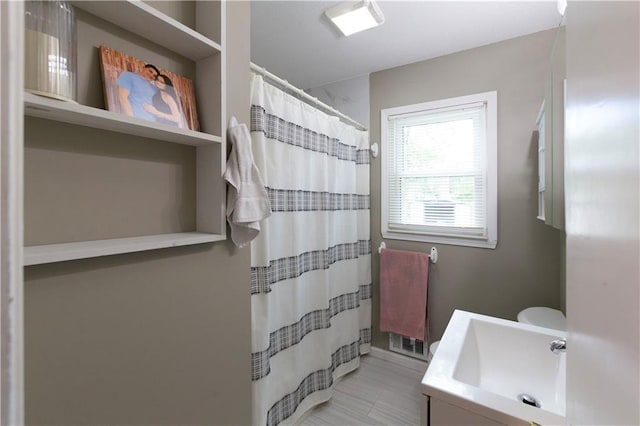 8401 England St, Overland Park, KS 66212 - full bathroom featuring vanity, curtained shower, and tile patterned flooring