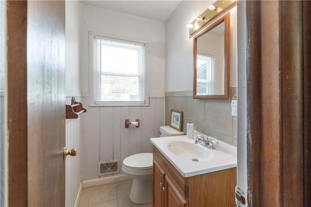 8401 England St, Overland Park, KS 66212 - bathroom featuring tile patterned flooring, wainscoting, toilet, and vanity