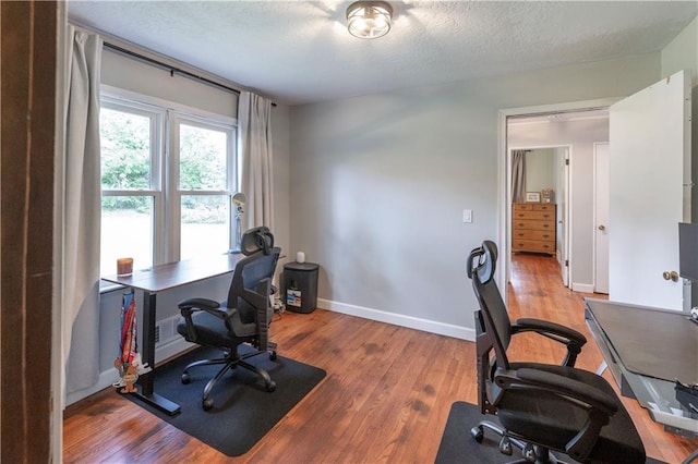 8401 England St, Overland Park, KS 66212 - home office featuring wood finished floors, a textured ceiling, and baseboards