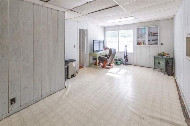 8401 England St, Overland Park, KS 66212 - below grade area featuring tile patterned floors, wooden walls, and a desk