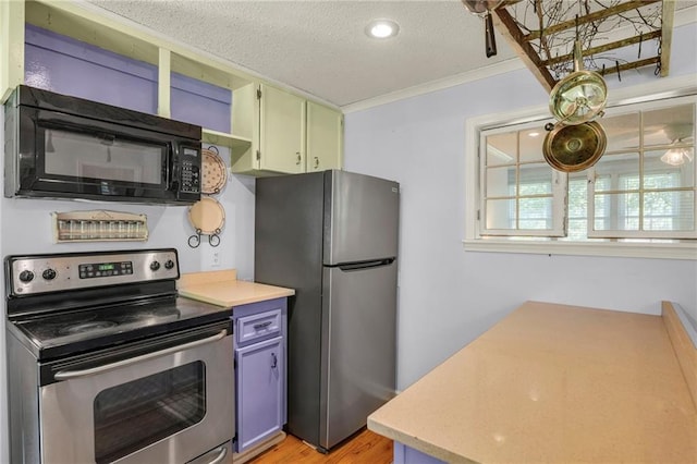 10916 Grandview Rd, Kansas City, MO 64137 - kitchen with appliances with stainless steel finishes, light countertops, a textured ceiling, light wood-type flooring, and ornamental molding