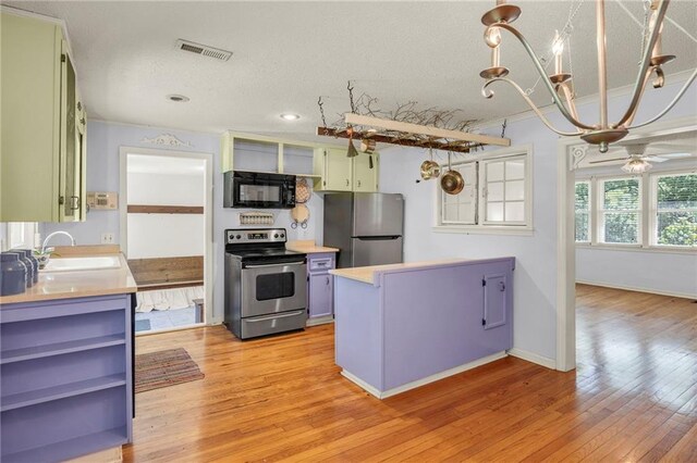 10916 Grandview Rd, Kansas City, MO 64137 - kitchen with stainless steel appliances, a sink, open shelves, green cabinetry, and a textured ceiling