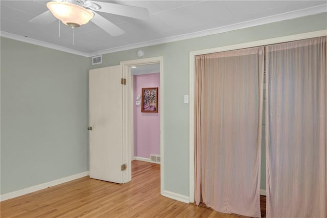 10916 Grandview Rd, Kansas City, MO 64137 - unfurnished bedroom with crown molding, light wood-style flooring, baseboards, and a ceiling fan
