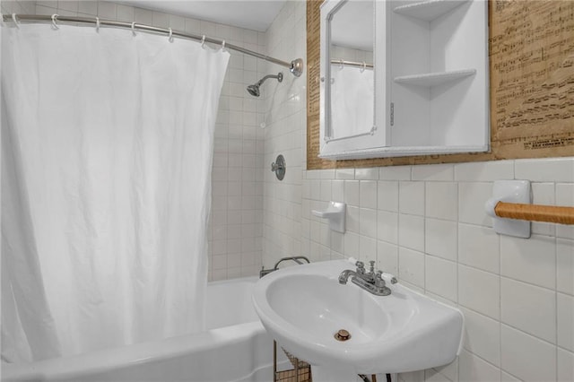 10916 Grandview Rd, Kansas City, MO 64137 - full bath featuring a sink, tile walls, and shower / bathtub combination with curtain
