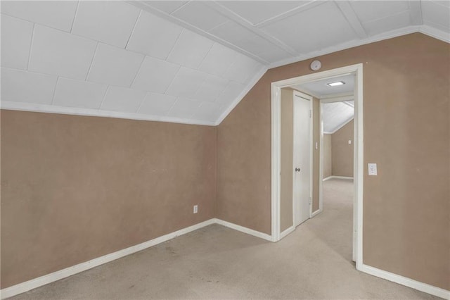 10916 Grandview Rd, Kansas City, MO 64137 - additional living space with lofted ceiling, baseboards, and light colored carpet