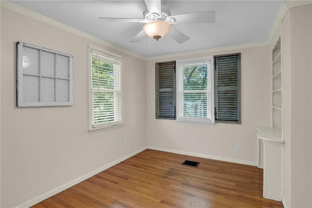 10916 Grandview Rd, Kansas City, MO 64137 - empty room featuring baseboards, wood finished floors, crown molding, and a ceiling fan