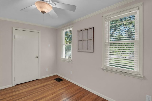 10916 Grandview Rd, Kansas City, MO 64137 - unfurnished room featuring baseboards, wood finished floors, ornamental molding, and a ceiling fan