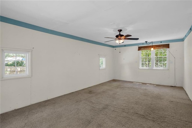 10916 Grandview Rd, Kansas City, MO 64137 - carpeted spare room featuring healthy amount of natural light and ceiling fan