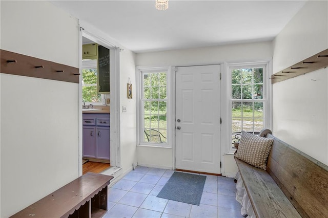 10916 Grandview Rd, Kansas City, MO 64137 - foyer entrance featuring healthy amount of natural light and light tile patterned flooring