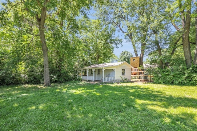 10916 Grandview Rd, Kansas City, MO 64137 - view of grassy yard featuring covered porch