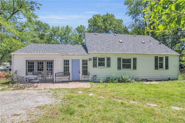 10916 Grandview Rd, Kansas City, MO 64137 - rear view of house featuring roof with shingles, a yard, and a patio