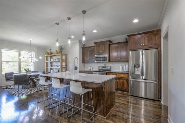 1644 Woodland Shores Cir, Lees Summit, MO 64086 - kitchen with stainless steel appliances, a sink, ornamental molding, dark wood finished floors, and an island with sink