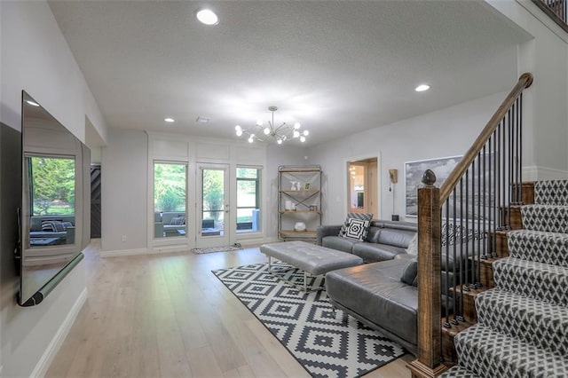 1644 Woodland Shores Cir, Lees Summit, MO 64086 - living area featuring a chandelier, wood finished floors, baseboards, recessed lighting, and stairs