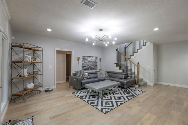 1644 Woodland Shores Cir, Lees Summit, MO 64086 - living room featuring light wood-style floors, a chandelier, baseboards, a textured ceiling, and recessed lighting