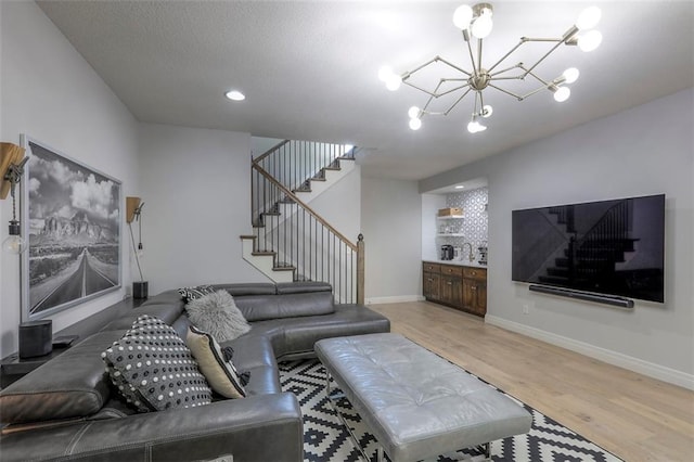 1644 Woodland Shores Cir, Lees Summit, MO 64086 - living room featuring stairway, a chandelier, light wood finished floors, baseboards, and recessed lighting