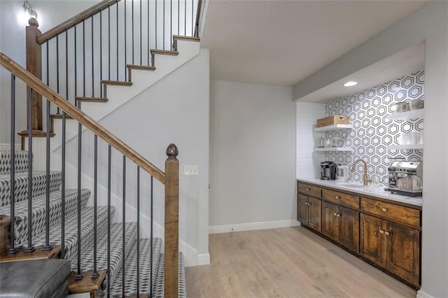 1644 Woodland Shores Cir, Lees Summit, MO 64086 - bar featuring light wood-style floors, baseboards, stairway, and recessed lighting