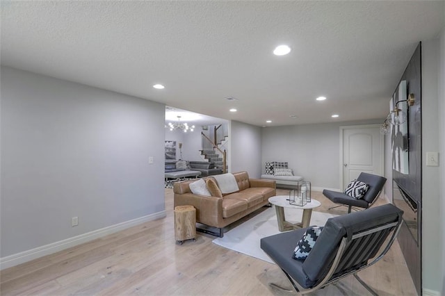 1644 Woodland Shores Cir, Lees Summit, MO 64086 - living area with stairs, baseboards, light wood-style floors, recessed lighting, and a textured ceiling