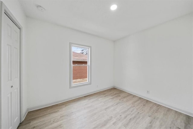 1514 N 25th St, Kansas City, KS 66102 - unfurnished bedroom with light wood-style floors, a closet, baseboards, and recessed lighting