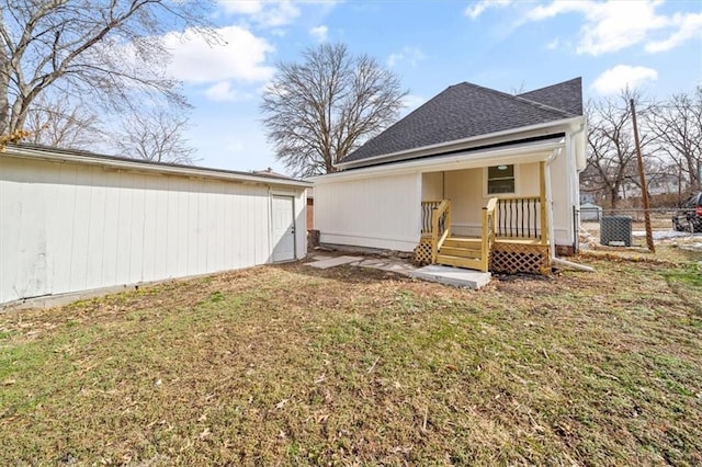 1514 N 25th St, Kansas City, KS 66102 - rear view of property featuring a shingled roof and an outbuilding