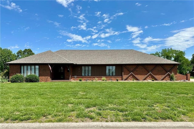 917 Country Club Dr, Butler, MO 64730 - view of front of home with a front lawn, brick siding, and a shingled roof