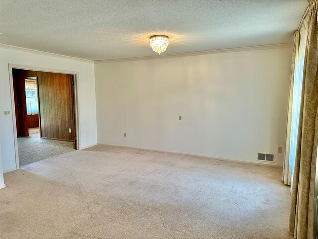917 Country Club Dr, Butler, MO 64730 - carpeted empty room featuring ornamental molding and a textured ceiling