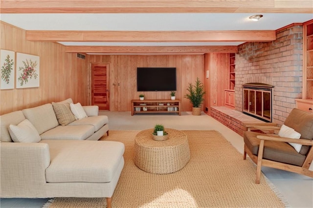 917 Country Club Dr, Butler, MO 64730 - living room featuring beam ceiling, wood walls, a brick fireplace, and carpet