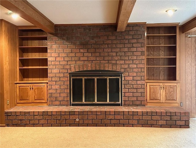 917 Country Club Dr, Butler, MO 64730 - detailed view of beam ceiling, a fireplace, built in features, carpet, and a textured ceiling