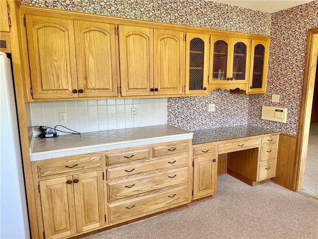 917 Country Club Dr, Butler, MO 64730 - kitchen featuring decorative backsplash, glass insert cabinets, freestanding refrigerator, and tile counters