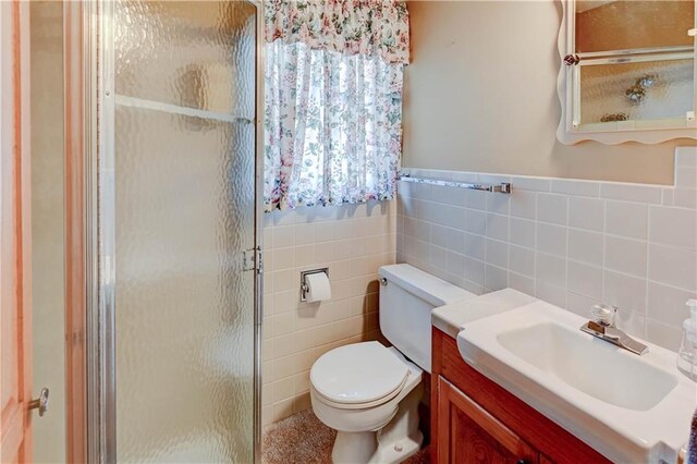 917 Country Club Dr, Butler, MO 64730 - bathroom with a stall shower, vanity, and tile walls