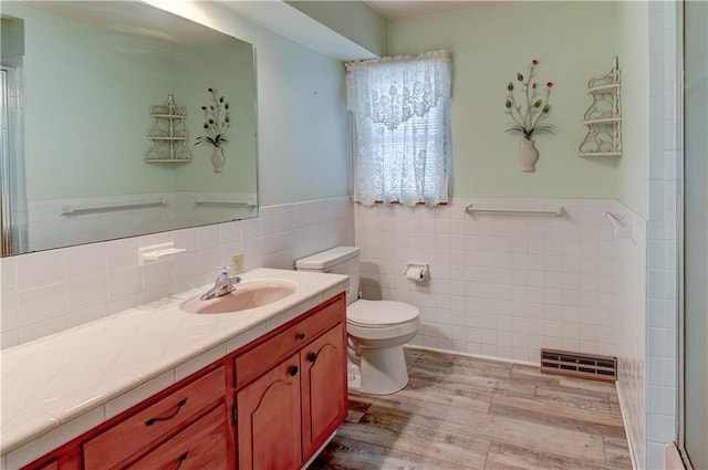 917 Country Club Dr, Butler, MO 64730 - full bath with vanity, tile walls, wood finished floors, an enclosed shower, and wainscoting