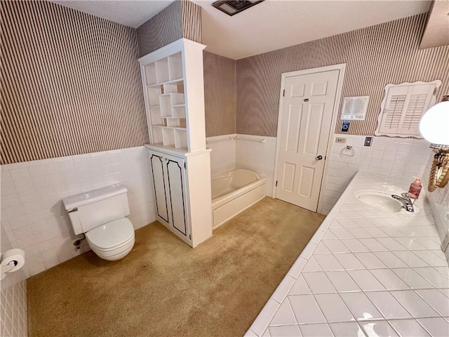 917 Country Club Dr, Butler, MO 64730 - bathroom featuring a wainscoted wall, wallpapered walls, a garden tub, double vanity, and tile walls