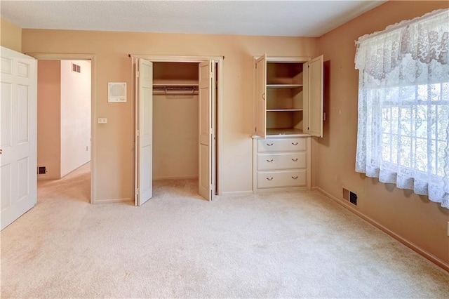 917 Country Club Dr, Butler, MO 64730 - unfurnished bedroom featuring a closet and light carpet