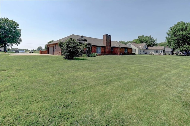 917 Country Club Dr, Butler, MO 64730 - view of grassy yard with a garage