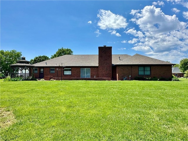 917 Country Club Dr, Butler, MO 64730 - back of house with a gazebo, a yard, a chimney, and brick siding