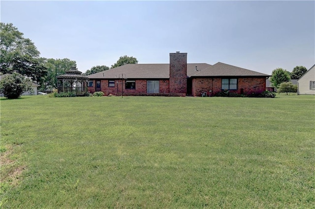 917 Country Club Dr, Butler, MO 64730 - back of property featuring a gazebo, a chimney, a lawn, and brick siding