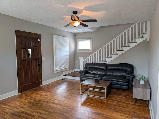 117 W N St, Warrensburg, MO 64093 - foyer featuring stairs, wood finished floors, baseboards, ceiling fan, and a textured ceiling