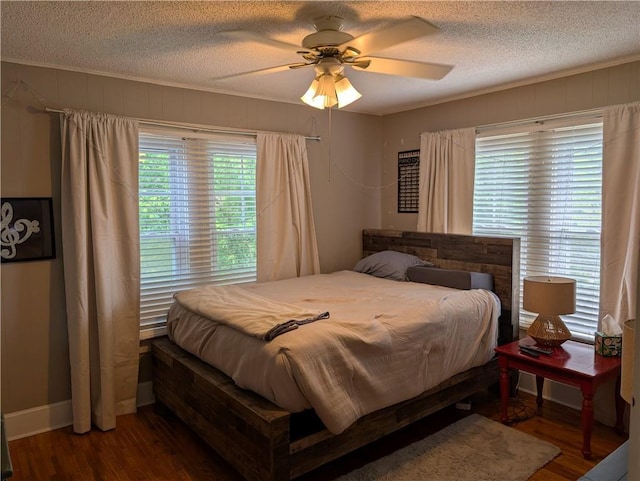 117 W N St, Warrensburg, MO 64093 - bedroom with wood finished floors, a textured ceiling, a ceiling fan, and crown molding