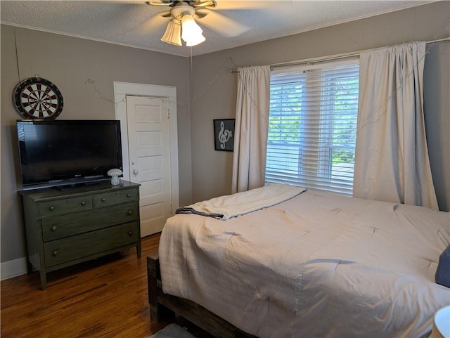 117 W N St, Warrensburg, MO 64093 - bedroom with wood finished floors, a textured ceiling, and ceiling fan