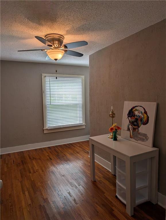 117 W N St, Warrensburg, MO 64093 - interior space featuring a textured ceiling, wood finished floors, ceiling fan, and baseboards
