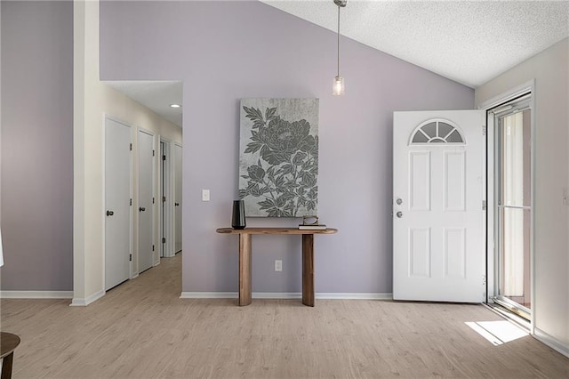 7243 Rene St, Shawnee, KS 66216 - foyer entrance featuring wood finished floors, vaulted ceiling, baseboards, and a textured ceiling