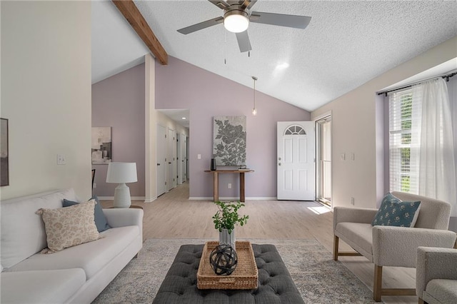 7243 Rene St, Shawnee, KS 66216 - living area featuring wood finished floors, beamed ceiling, ceiling fan, high vaulted ceiling, and a textured ceiling
