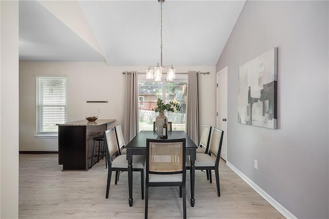 7243 Rene St, Shawnee, KS 66216 - dining area featuring lofted ceiling, a chandelier, light wood finished floors, and baseboards