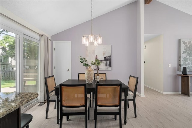 7243 Rene St, Shawnee, KS 66216 - dining room with light wood finished floors, a chandelier, high vaulted ceiling, and baseboards
