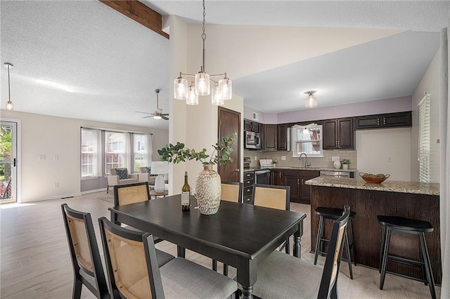 7243 Rene St, Shawnee, KS 66216 - dining area featuring lofted ceiling, plenty of natural light, ceiling fan, light wood-style floors, and a chandelier